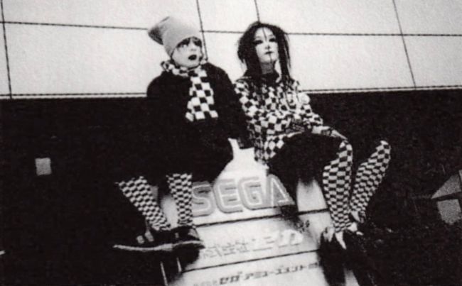 Uyuni and Satetsu sitting on a SEGA sign